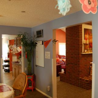 A cozy home interior featuring a hallway leading to a living area with brick accent walls.