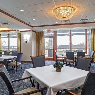 Elegant dining area with neatly arranged tables and large windows.
