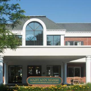 A modern building with large windows and a welcoming entrance.