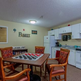 A cozy kitchen and dining area with a table set up for a game of checkers.