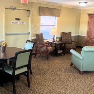 A cozy living room with comfortable seating, a table, and a warm lighting ambiance.