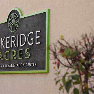 A sign for Bakeridge Acres, a rehabilitation center, displayed prominently outside the building.