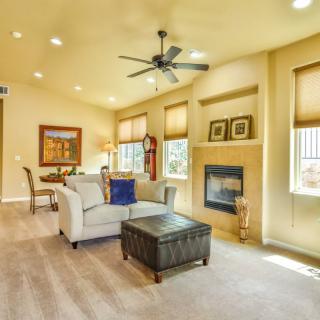 A spacious and well-lit living room with modern furnishings, featuring a comfortable sofa, a fireplace, and tasteful decor.