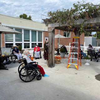 Residents engaging in a community activity outside a care facility.
