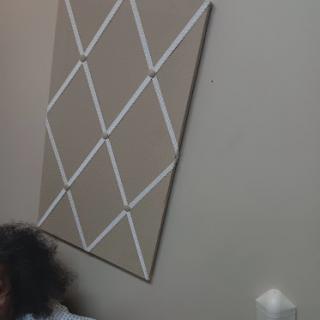 A cozy indoor setting featuring a unique wall decoration and a person relaxing.