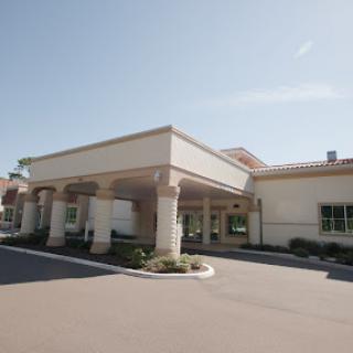 A welcoming entrance to a commercial building on a bright sunny day.