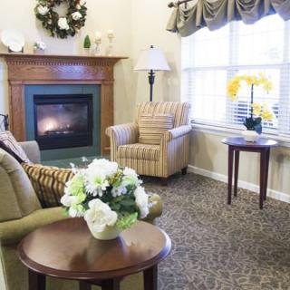 A cozy living room with a fireplace and comfortable seating.