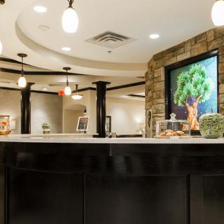 A modern reception area featuring elegant lighting, artwork, and contemporary interior design.