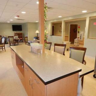 A spacious and well-lit kitchen and dining area with a large countertop and seating.