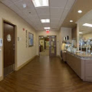 A welcoming interior of a medical facility, featuring a well-lit hallway and reception area.