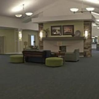 A modern lobby area featuring comfortable seating and a cozy fireplace.