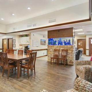 Spacious living area featuring a dining table, comfortable seating, and an aquarium.