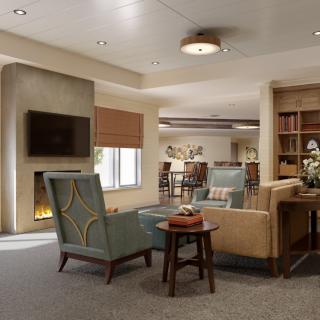 A cozy living room with comfortable seating, a fireplace, and a bookshelf.
