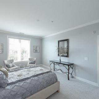 A modern minimalist bedroom with natural light and stylish decor.