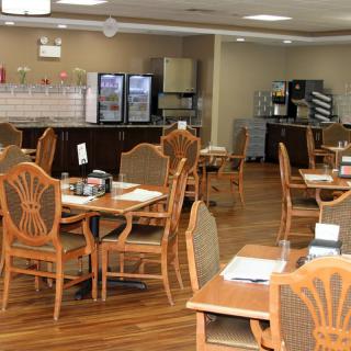An empty dining area with neatly arranged tables and chairs.