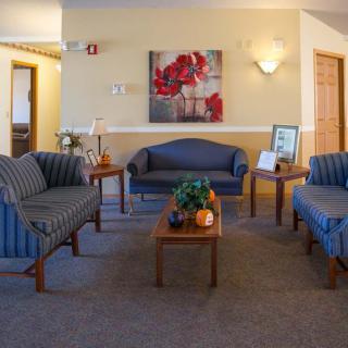 A cozy waiting room with comfortable seating and warm decor.