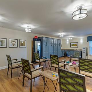 A modern meeting space with arranged chairs and artwork on the walls.