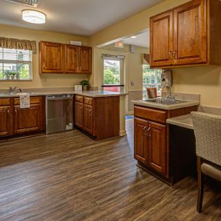 A spacious and modern kitchen featuring elegant wooden cabinetry and an open layout that invites natural light.