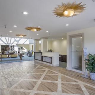 A modern lobby with elegant lighting fixtures and patterned flooring.