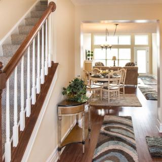Bright and inviting home interior with a view of the dining area from the hallway.
