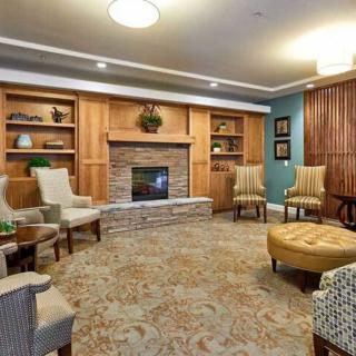 A cozy living room with a fireplace and comfortable seating area.