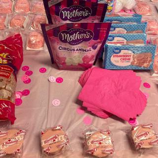 A vibrant display of pink snacks and party items, perfect for a sweet celebration.