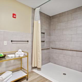 Accessible bathroom with a spacious shower and safety features.