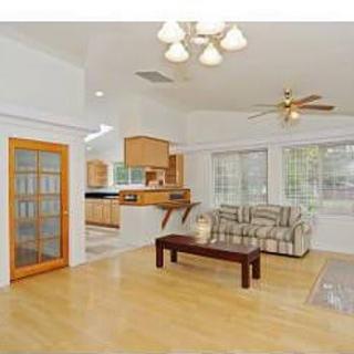 Spacious living room with hardwood floors and open layout.
