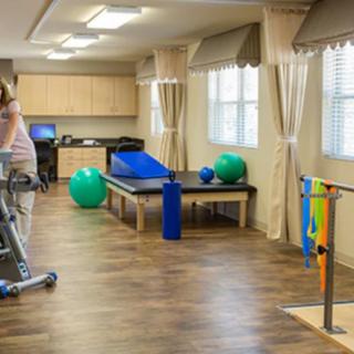 A rehabilitation center with exercise equipment and therapy tools.
