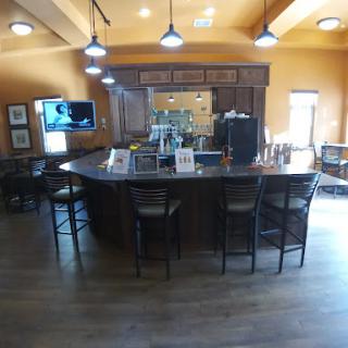 A cozy and inviting bar area with wooden finishes and warm lighting.