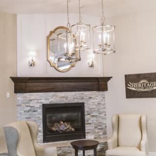 A stylish and inviting living room featuring a contemporary fireplace, elegant light fixtures, and comfortable seating.