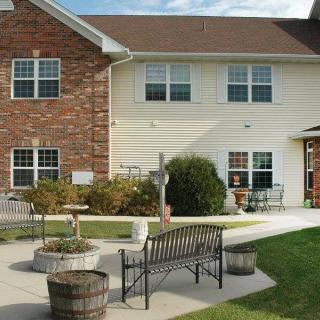 A comfortable outdoor seating area in front of a residential building.