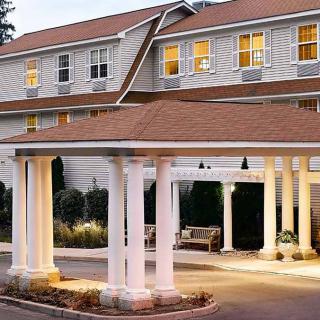 An elegant hotel entrance illuminated during the evening.