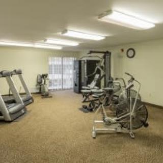 A small gym with exercise equipment including treadmills and a stationary bike.