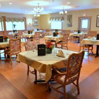 A spacious and inviting dining room setup with neatly arranged tables and chairs.