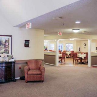 A welcoming lobby area with seating and a view into the dining area.
