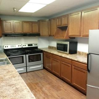 A modern kitchen with wooden cabinets and stainless steel appliances.