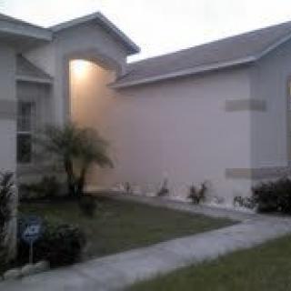 Exterior view of a residential house with a well-maintained lawn.