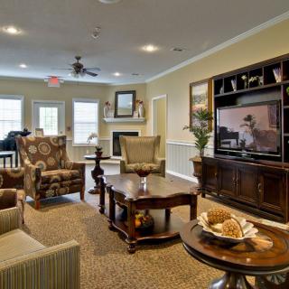 A cozy living room with comfortable seating and a large entertainment center.