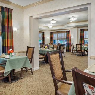 A view of a well-lit dining area with neatly arranged tables and chairs.