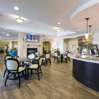 A modern cafe interior with seating and a counter.