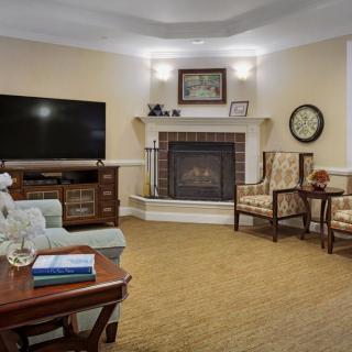 A cozy living room with a fireplace, television, and comfortable seating.