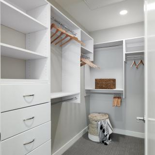 A well-organized walk-in closet with shelves and hangers.
