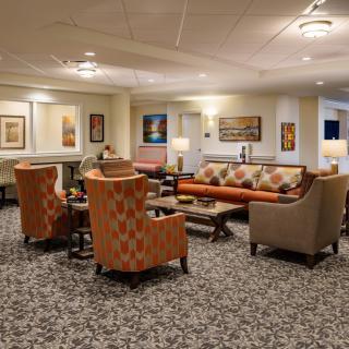 A cozy lobby with comfortable seating and warm lighting.