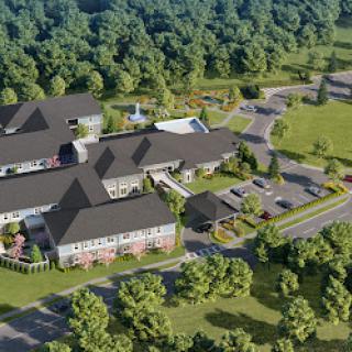 Aerial view of a modern residential complex surrounded by lush greenery.