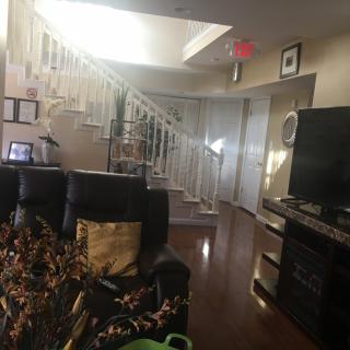 A cozy living room space with a staircase and modern decor.