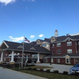 A hotel building with an American flag against a blue sky.