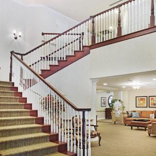 Elegant staircase leading to an open living area with comfortable seating.