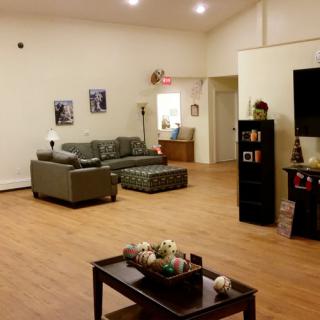 A spacious living room with a comfortable sofa set, coffee table, and tasteful decor.