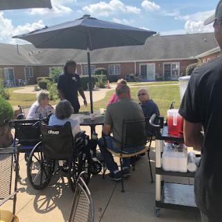 Residents enjoying a sunny day together at an outdoor gathering.
